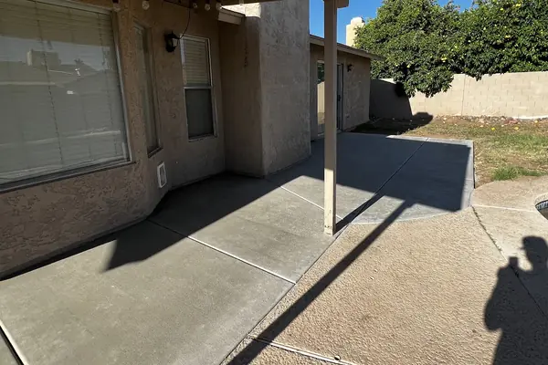 A new concrete patio slab under a covered patio, poured by our featured contractor