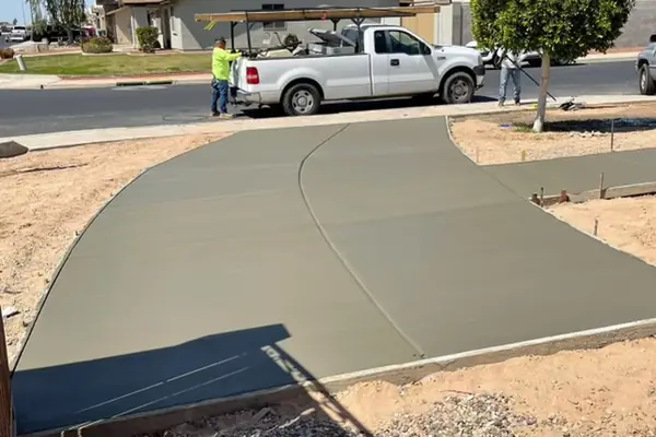 A freshly poured curved concrete driveway by our featured contractor